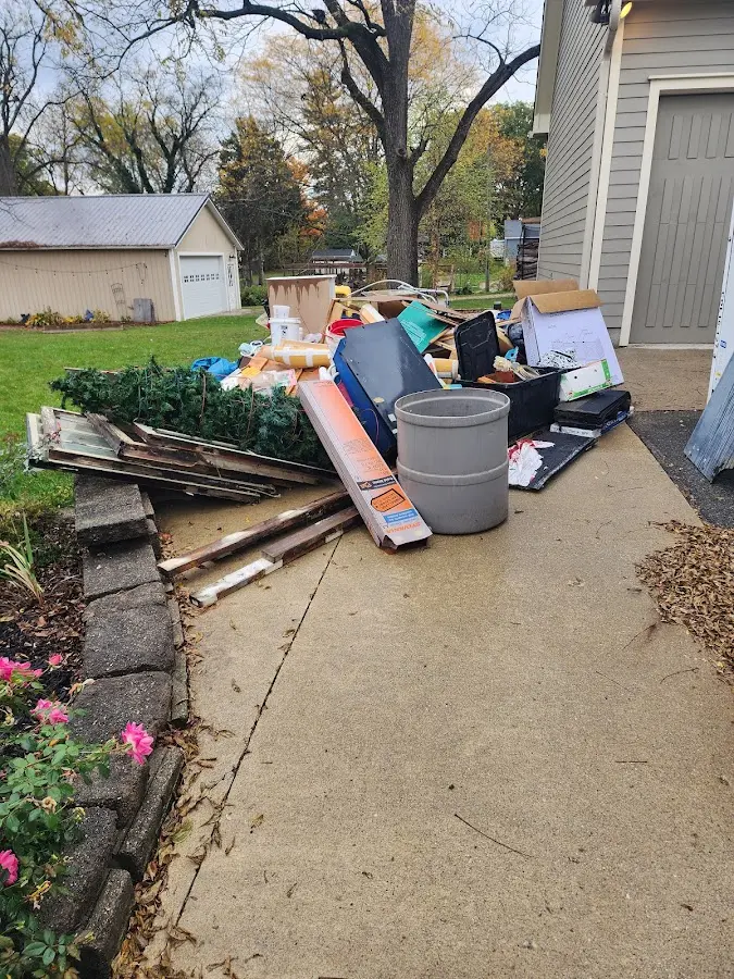 Dumpster being loaded with debris for 10 Yard Dumpster Rental in Superior